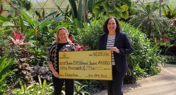 Lauren Burgeson presents a check to the Botanical Center.